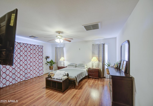 703 N Redwood Ln, Buckeye, AZ 85326 - bedroom with light wood-style flooring, multiple windows, and a ceiling fan