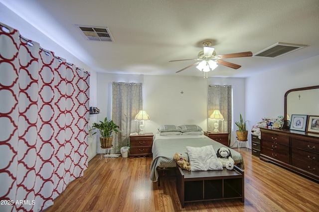 703 N Redwood Ln, Buckeye, AZ 85326 - bedroom with wood finished floors and a ceiling fan