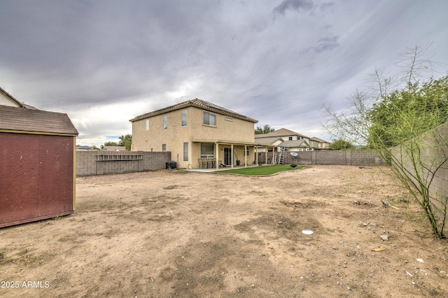 703 N Redwood Ln, Buckeye, AZ 85326 - rear view of house with a fenced backyard, a patio, and an outdoor structure