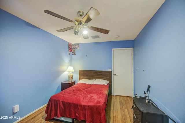703 N Redwood Ln, Buckeye, AZ 85326 - bedroom featuring wood finished floors, ceiling fan, and baseboards
