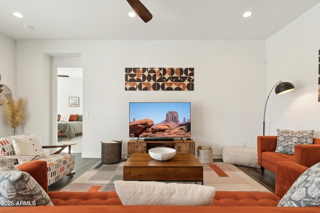 living room with ceiling fan and light hardwood / wood-style floors