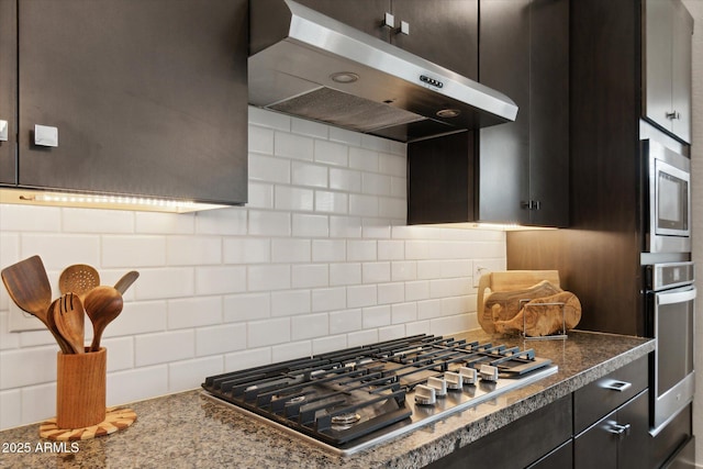 kitchen with stainless steel appliances, stone counters, and decorative backsplash