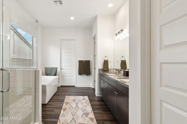 bathroom with vanity, separate shower and tub, and wood-type flooring