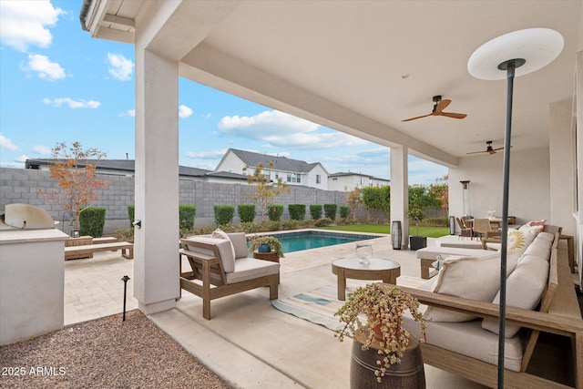 view of patio with an outdoor living space, area for grilling, a fenced in pool, and ceiling fan