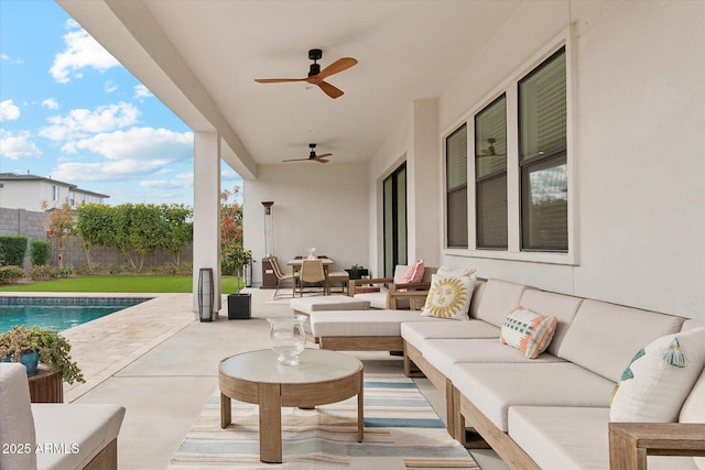 view of patio featuring an outdoor living space, a fenced in pool, and ceiling fan