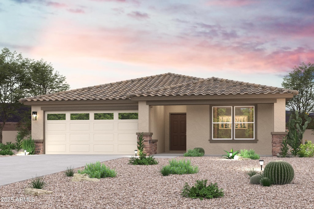 view of front of property with a garage, driveway, a tiled roof, and stucco siding