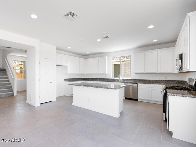 14634 W Sand Hills Rd, Surprise, AZ 85387 - kitchen featuring stainless steel appliances, healthy amount of natural light, recessed lighting, white cabinetry, and light tile patterned floors