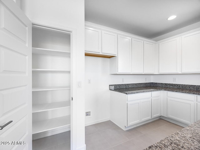 14634 W Sand Hills Rd, Surprise, AZ 85387 - kitchen with light tile patterned floors, white cabinets, dark stone countertops, and recessed lighting