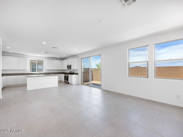 14634 W Sand Hills Rd, Surprise, AZ 85387 - unfurnished living room with recessed lighting, light tile patterned floors, and baseboards