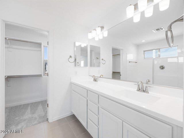 14634 W Sand Hills Rd, Surprise, AZ 85387 - full bath featuring a spacious closet, double vanity, tile patterned floors, and baseboards