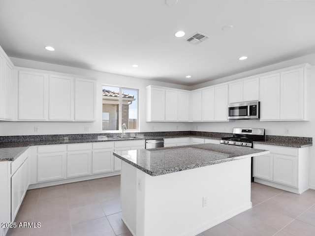 14634 W Sand Hills Rd, Surprise, AZ 85387 - kitchen with appliances with stainless steel finishes, light tile patterned flooring, white cabinetry, and recessed lighting
