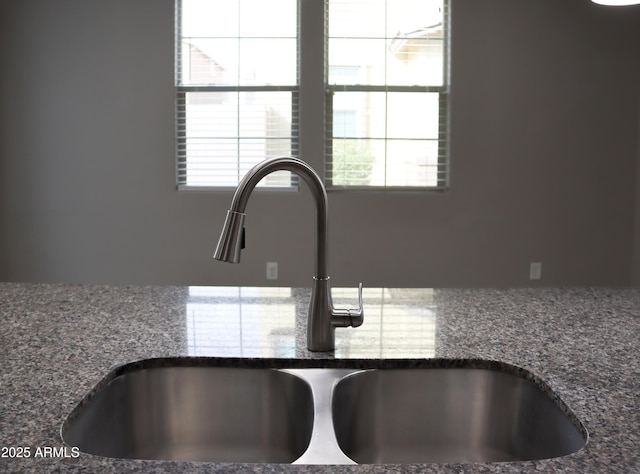 details with a sink and dark stone counters