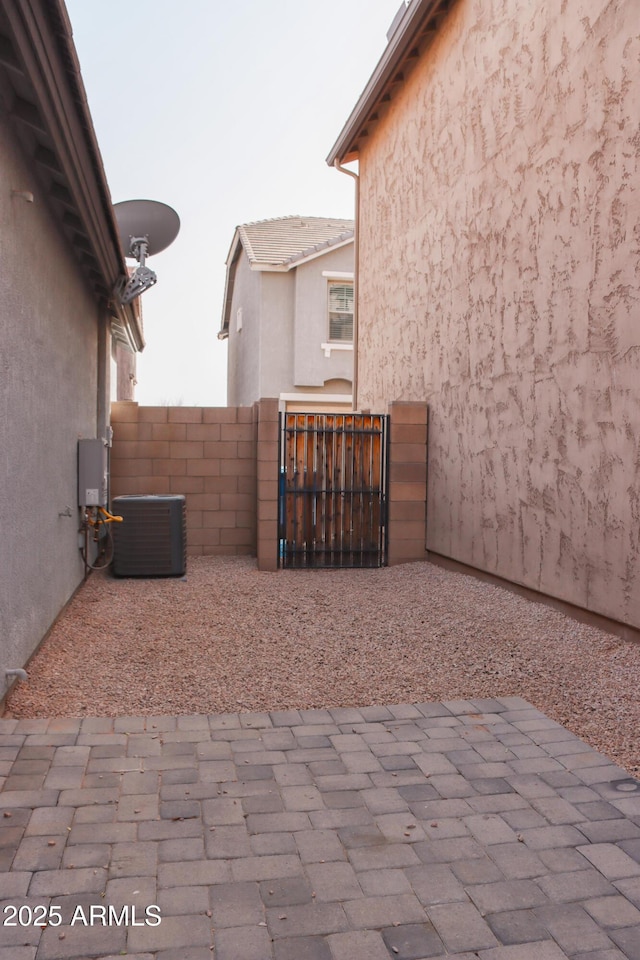 view of patio / terrace featuring a gate, cooling unit, and fence