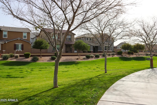 view of property's community featuring a residential view and a lawn