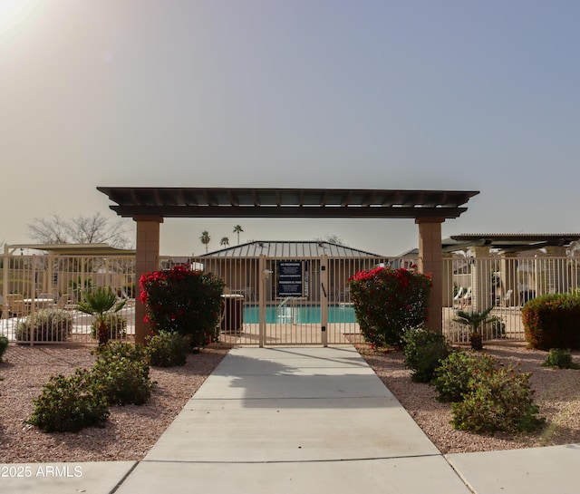 view of patio with a community pool and fence