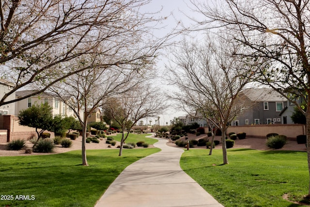 view of community featuring a yard and a residential view