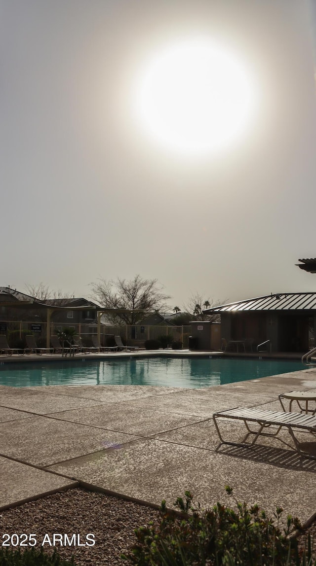 pool featuring a patio and fence