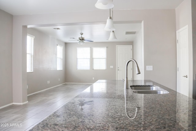 kitchen with visible vents, pendant lighting, a ceiling fan, and a sink