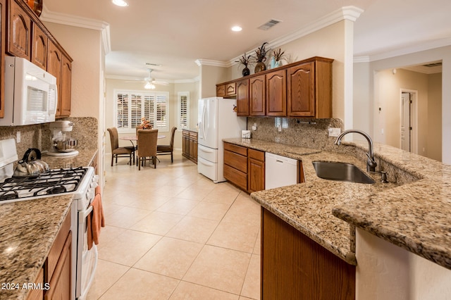 kitchen featuring ornamental molding, backsplash, ceiling fan, and white appliances