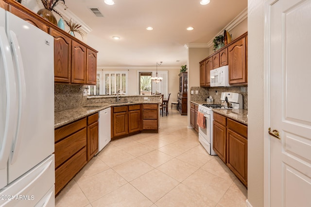 kitchen featuring decorative light fixtures, backsplash, white appliances, and crown molding