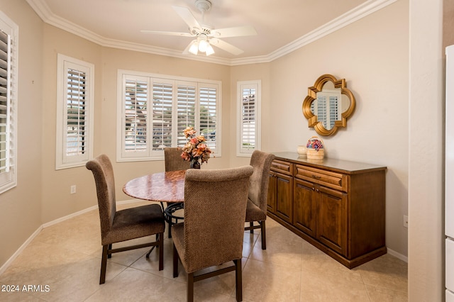 tiled dining space with crown molding and ceiling fan