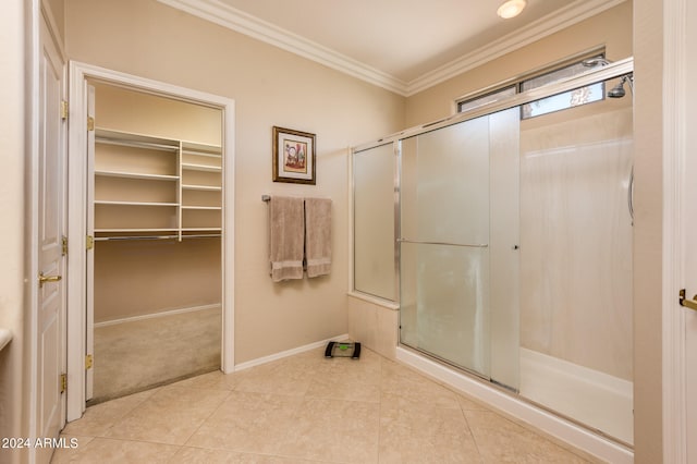 bathroom with tile flooring, ornamental molding, and an enclosed shower