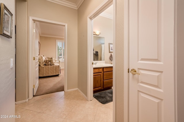 bathroom featuring tile flooring, crown molding, and vanity