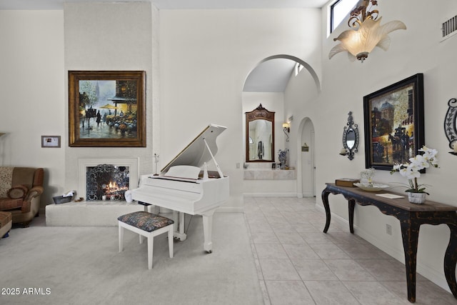 foyer featuring light tile patterned flooring and a high ceiling