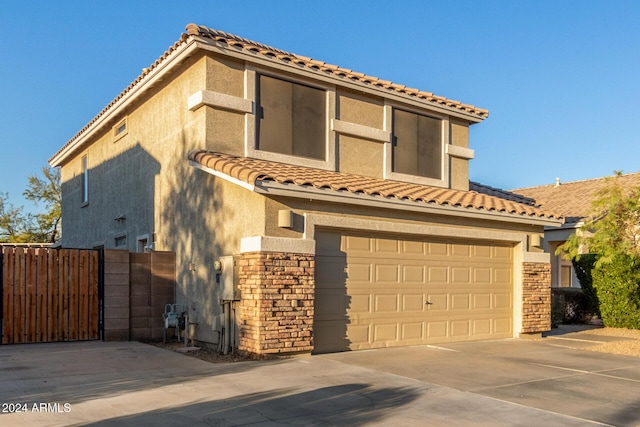 mediterranean / spanish home with a garage