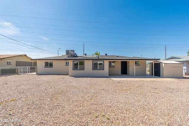 back of property featuring a patio area, a shed, central air condition unit, an outdoor structure, and fence