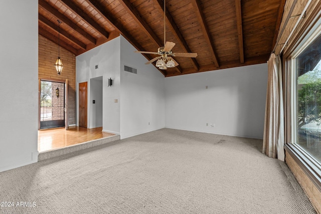 carpeted spare room with high vaulted ceiling, beam ceiling, wood ceiling, and ceiling fan