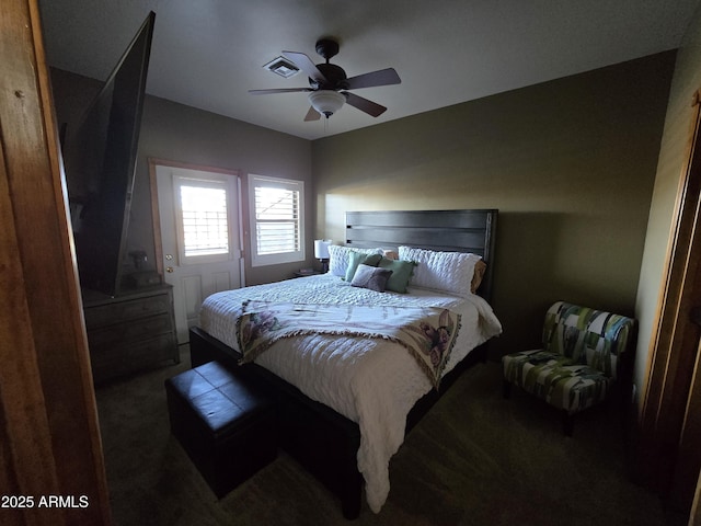 bedroom featuring ceiling fan and dark colored carpet