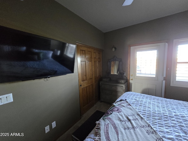 bedroom with lofted ceiling and ceiling fan