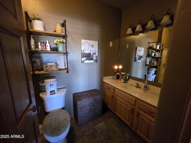 bathroom with vanity, tile patterned floors, and toilet