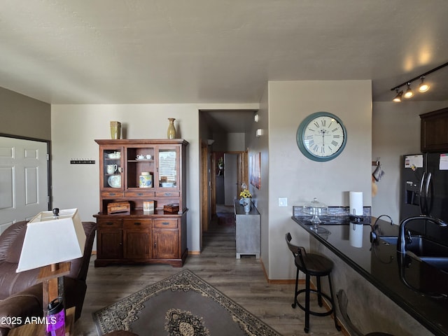 interior space featuring track lighting and dark hardwood / wood-style flooring