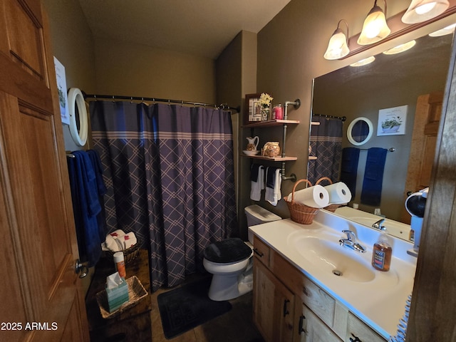 bathroom featuring vanity, toilet, and walk in shower