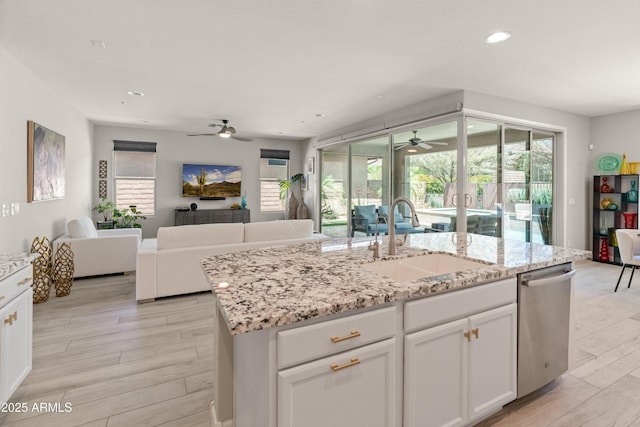 13186 W Via Dona Rd, Peoria, AZ 85383 - kitchen with a sink, a ceiling fan, dishwasher, open floor plan, and white cabinets