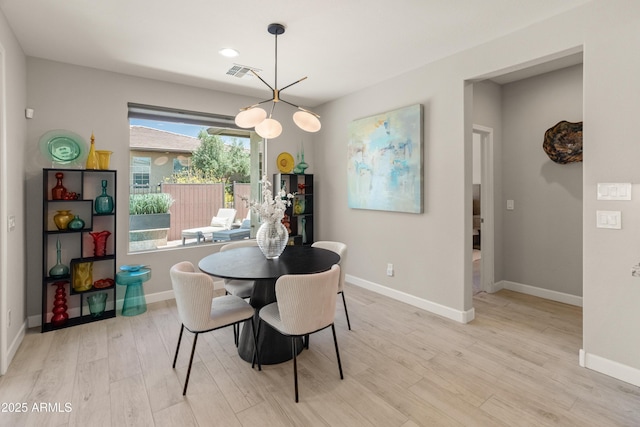 13186 W Via Dona Rd, Peoria, AZ 85383 - dining room with light wood-style floors, baseboards, and a chandelier