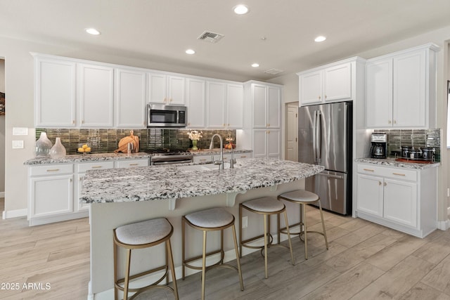 13186 W Via Dona Rd, Peoria, AZ 85383 - kitchen featuring appliances with stainless steel finishes, tasteful backsplash, white cabinetry, and recessed lighting