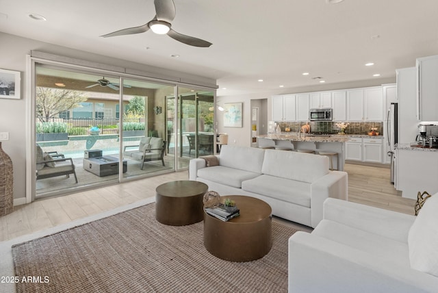 13186 W Via Dona Rd, Peoria, AZ 85383 - living area with a ceiling fan, light wood-style floors, and recessed lighting