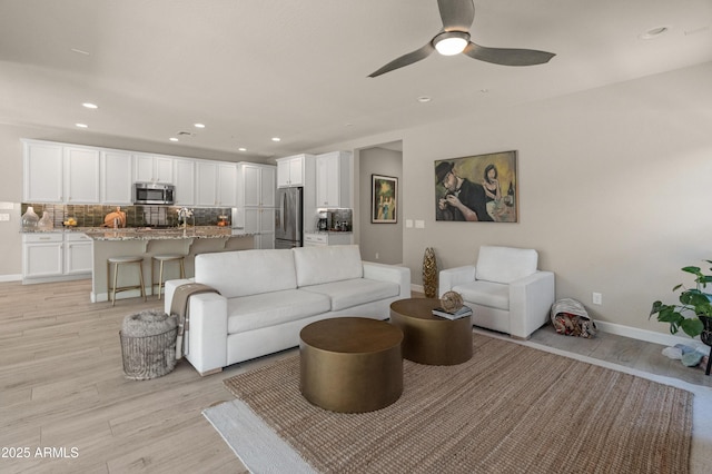 13186 W Via Dona Rd, Peoria, AZ 85383 - living area featuring light wood-style floors, baseboards, ceiling fan, and recessed lighting
