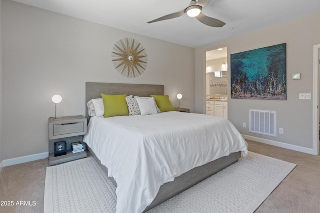 13186 W Via Dona Rd, Peoria, AZ 85383 - bedroom featuring light colored carpet, baseboards, ensuite bathroom, and ceiling fan