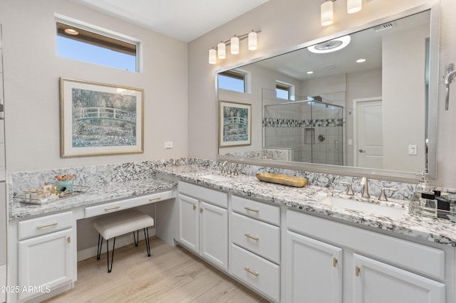 13186 W Via Dona Rd, Peoria, AZ 85383 - bathroom with plenty of natural light, double vanity, a stall shower, and wood finished floors