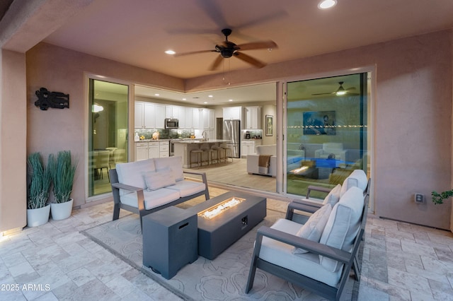13186 W Via Dona Rd, Peoria, AZ 85383 - view of patio with a ceiling fan and an outdoor living space with a fire pit