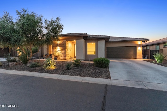 13186 W Via Dona Rd, Peoria, AZ 85383 - prairie-style house featuring a garage, driveway, stucco siding, and a tiled roof