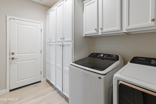 13186 W Via Dona Rd, Peoria, AZ 85383 - washroom featuring washer and dryer, cabinet space, light wood-type flooring, and baseboards