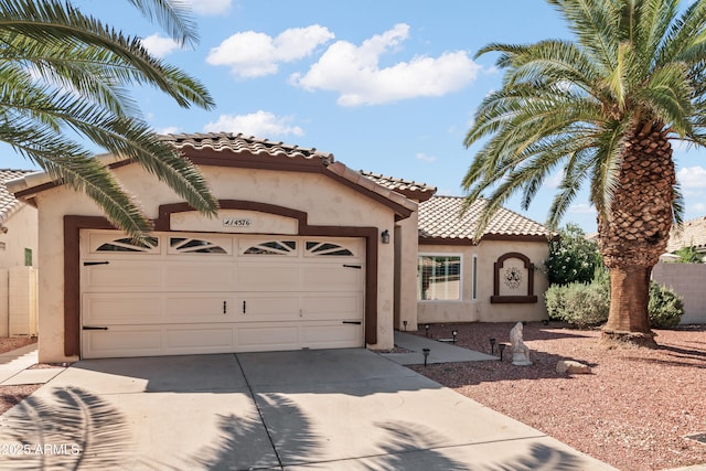 14576 W Raindance Rd, Surprise, AZ 85374 - mediterranean / spanish house featuring driveway, stucco siding, a garage, and a tile roof