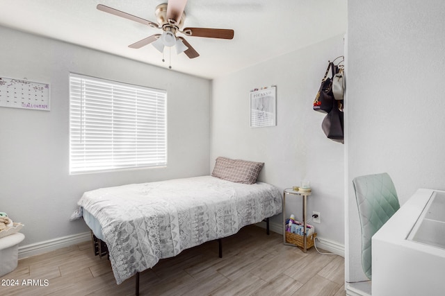 bedroom with ceiling fan and light hardwood / wood-style flooring