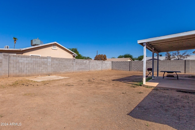 view of yard with cooling unit and a patio area