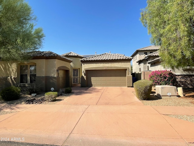 mediterranean / spanish-style home with a garage